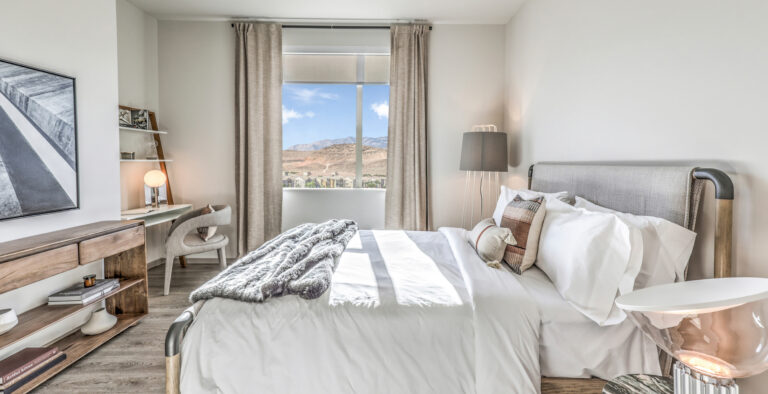 New Apartments in Las Vegas, NV - Vestra at Uncommons - White Bedroom with Window, Mountain Views, Bright Natural Light, and Desk